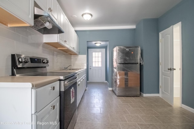 7180 Rte 209, Wawarsing, NY 12489 - kitchen with stainless steel electric range, white cabinets, range hood, light countertops, and backsplash