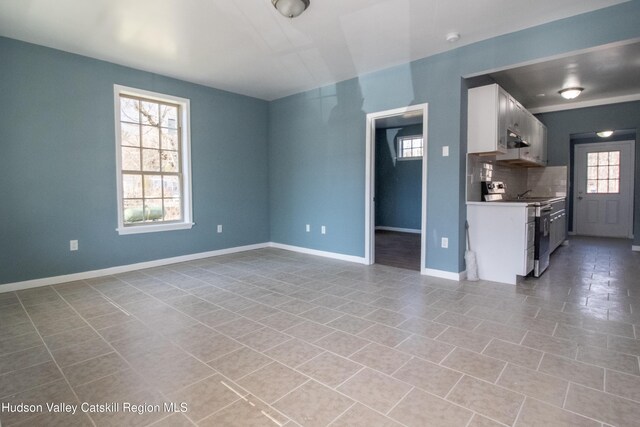 unfurnished living room featuring light tile patterned floors