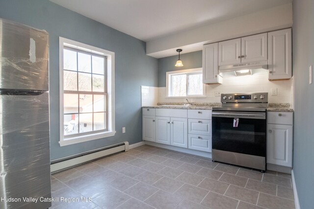 kitchen with decorative backsplash, stainless steel range with electric stovetop, a baseboard heating unit, decorative light fixtures, and white cabinetry