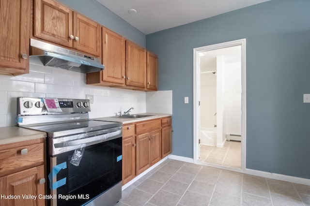 kitchen featuring sink, baseboard heating, backsplash, stainless steel electric range, and light tile patterned flooring