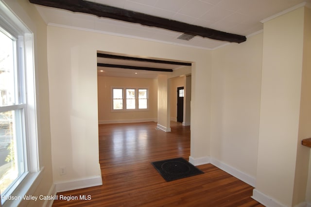 empty room featuring beam ceiling and dark hardwood / wood-style floors