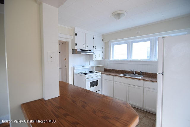 kitchen with sink, white appliances, white cabinetry, and light tile patterned flooring