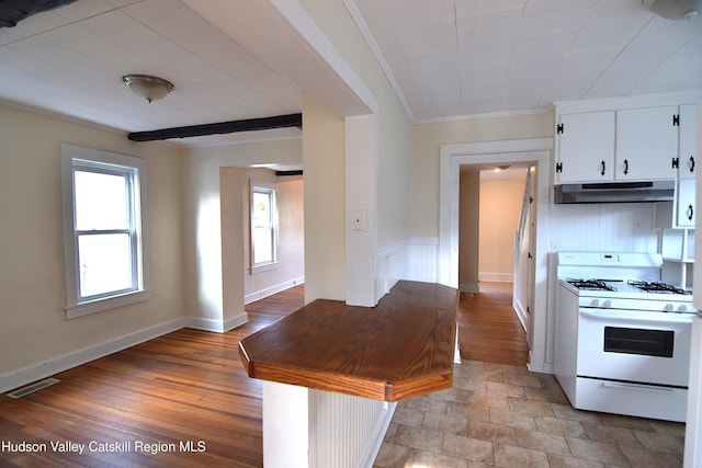 kitchen featuring white cabinetry, crown molding, light hardwood / wood-style flooring, and white range with gas stovetop