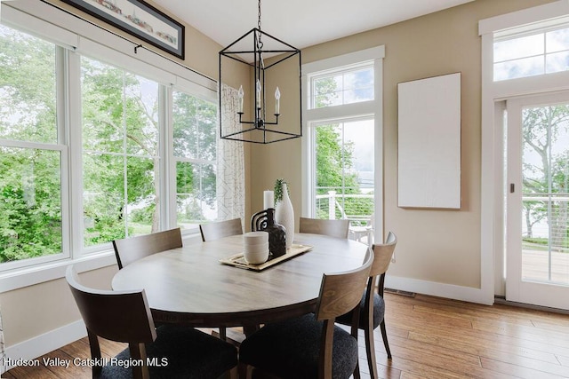 225 Lakeview Rd, Craryville, NY 12521 - dining area with a chandelier, healthy amount of natural light, and light wood-style flooring
