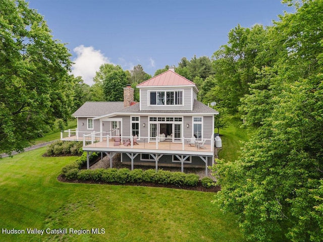 225 Lakeview Rd, Craryville, NY 12521 - rear view of property featuring a chimney, a wooden deck, a lawn, and a standing seam roof