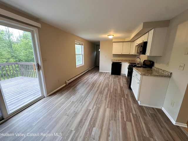 117 Sparling Rd, Saugerties, NY 12477 - kitchen featuring a baseboard heating unit, black appliances, a sink, light wood finished floors, and plenty of natural light