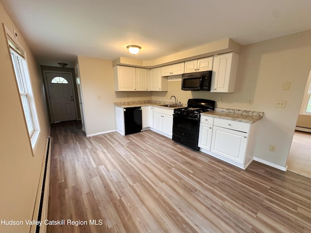 117 Sparling Rd, Saugerties, NY 12477 - kitchen featuring black appliances, a sink, baseboards, and light wood-style floors
