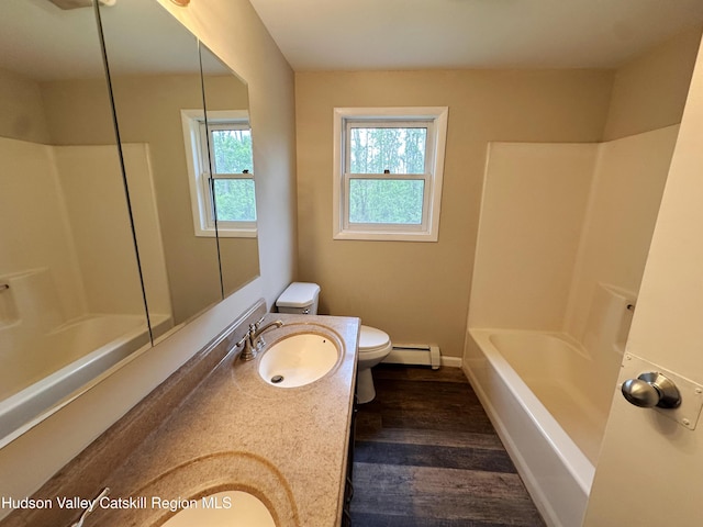 117 Sparling Rd, Saugerties, NY 12477 - full bathroom with a baseboard radiator, toilet, double vanity, wood finished floors, and bathtub / shower combination