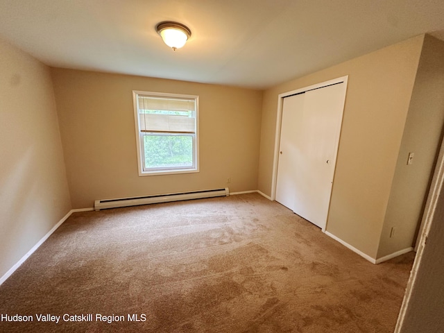 117 Sparling Rd, Saugerties, NY 12477 - unfurnished bedroom featuring a baseboard heating unit, carpet, a closet, and baseboards