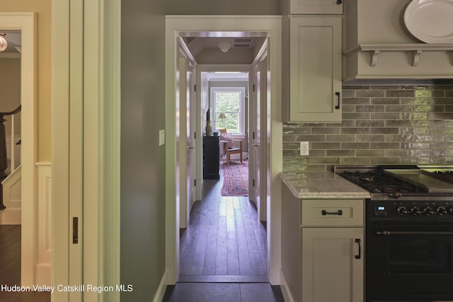 367 Cushetunk Dr, Cochecton Center, NY 12727 - kitchen featuring black gas range oven, decorative backsplash, light stone countertops, dark wood-style floors, and baseboards