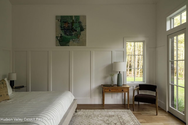 245 Brown Rd, Olivebridge, NY 12461 - bedroom featuring a decorative wall, light wood finished floors, and wainscoting