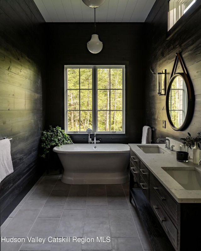245 Brown Rd, Olivebridge, NY 12461 - full bath with double vanity, wooden walls, a freestanding tub, tile patterned floors, and wooden ceiling