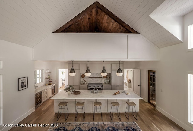 245 Brown Rd, Olivebridge, NY 12461 - kitchen with a wooden ceiling with exposed beams, a kitchen breakfast bar, dark wood finished floors, high vaulted ceiling, and light countertops