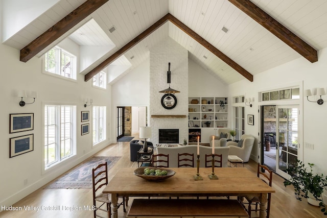 245 Brown Rd, Olivebridge, NY 12461 - dining room with wood finished floors, high vaulted ceiling, a fireplace, and a wooden ceiling with exposed beams