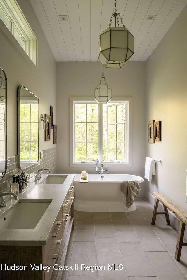 245 Brown Rd, Olivebridge, NY 12461 - bathroom with a soaking tub, double vanity, tile patterned floors, and backsplash