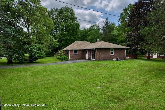 13 Birk St, Acra, NY 12405 - ranch-style house featuring a front lawn, asphalt driveway, brick siding, and a chimney