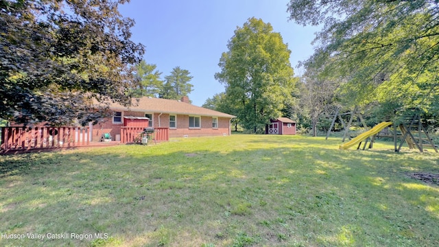 13 Birk St, Acra, NY 12405 - view of grassy yard featuring a storage unit, a playground, and a wooden deck