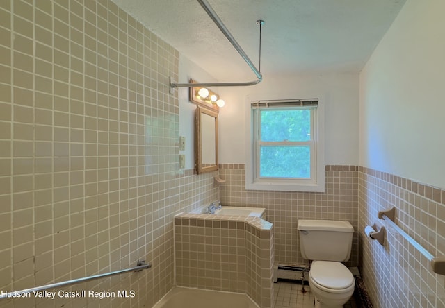 13 Birk St, Acra, NY 12405 - bathroom with tile walls, wainscoting, tile patterned flooring, and a baseboard radiator