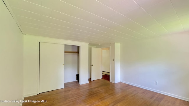 13 Birk St, Acra, NY 12405 - unfurnished bedroom with wood finished floors, a closet, and baseboard heating