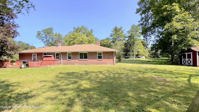 13 Birk St, Acra, NY 12405 - rear view of house with brick siding, a storage unit, a yard, and a chimney
