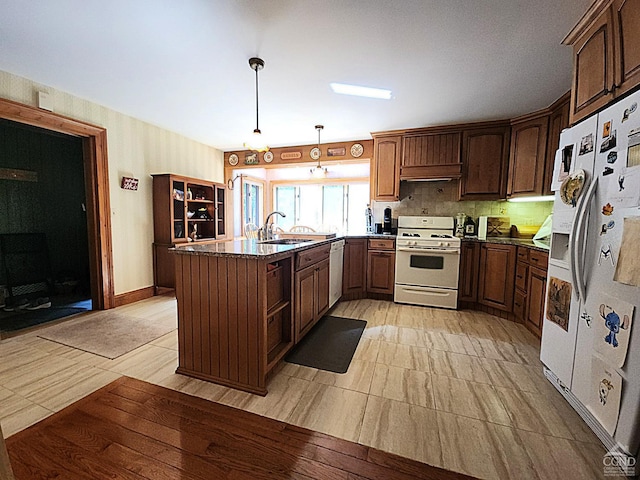 159 Toles Hollow Rd, Conesville, NY 12076 - kitchen featuring white appliances, a peninsula, range hood, decorative light fixtures, and a sink