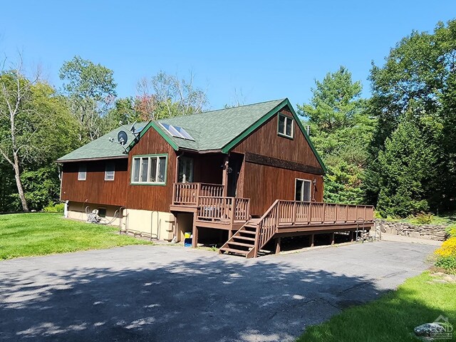 159 Toles Hollow Rd, Conesville, NY 12076 - rustic home with roof mounted solar panels, a front yard, and a deck