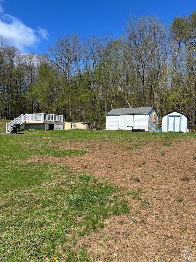 287 Shady Glen Rd, East Durham, NY 12423 - view of green lawn with a storage unit, an outdoor structure, and a deck