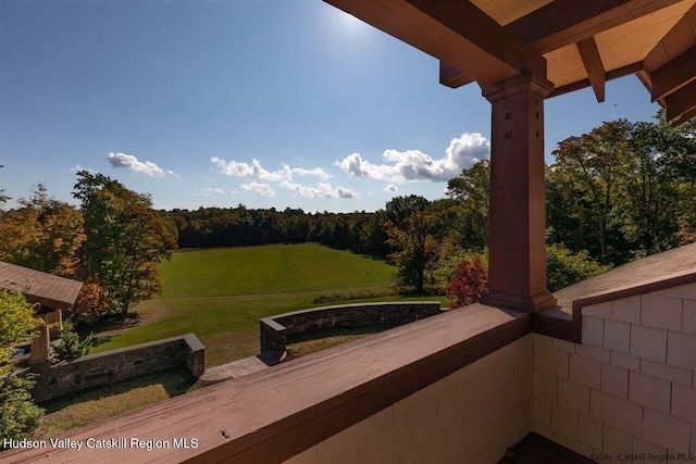 balcony featuring a view of trees