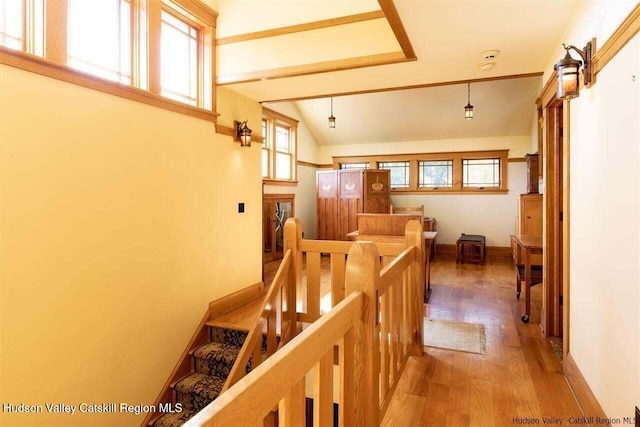 staircase featuring lofted ceiling and wood finished floors