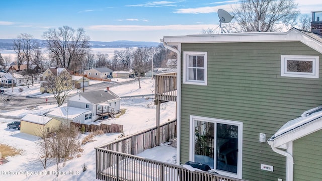 view of snowy exterior featuring a mountain view and a balcony