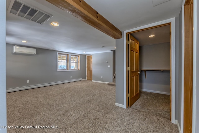 basement with carpet, visible vents, a baseboard heating unit, a wall mounted air conditioner, and baseboards