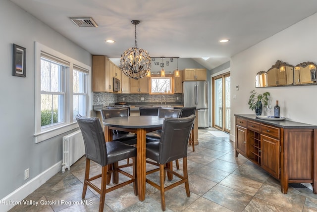 dining space featuring recessed lighting, visible vents, baseboards, radiator, and an inviting chandelier