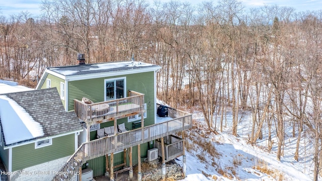 snow covered property with stairway