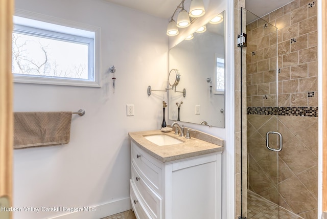 full bath with a stall shower and vanity