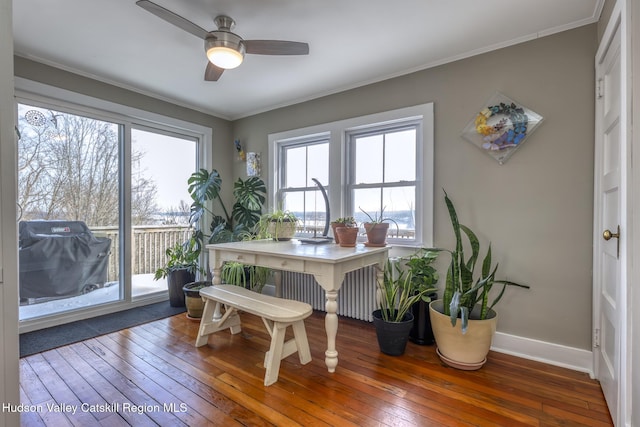 dining area with baseboards, a ceiling fan, hardwood / wood-style flooring, and crown molding