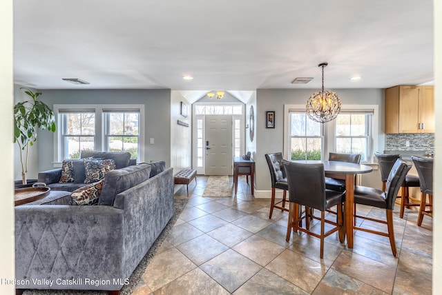 dining area featuring a wealth of natural light, visible vents, and baseboards