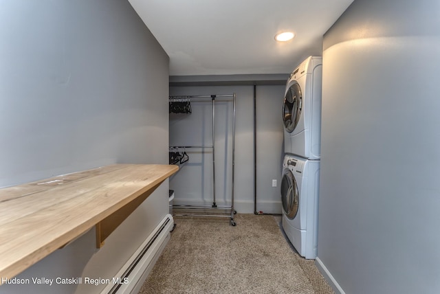 laundry area featuring stacked washer and dryer, baseboards, and light colored carpet