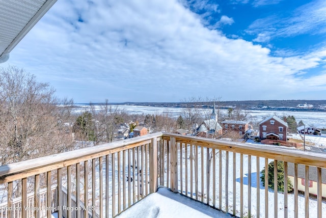 view of snow covered back of property