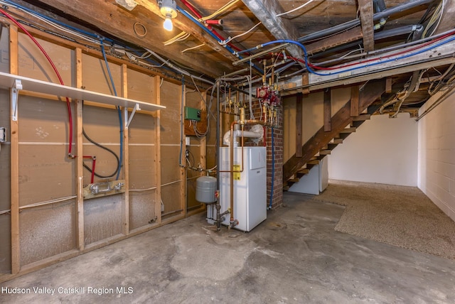 unfinished below grade area featuring water heater and stairway