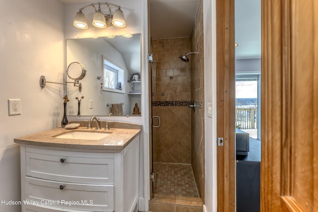 bathroom featuring a shower stall and vanity