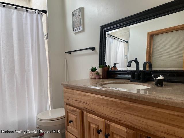87 Dock St, Saugerties, NY 12477 - bathroom with vanity, toilet, and a shower with curtain