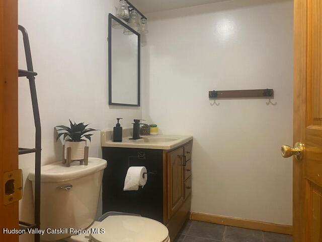 87 Dock St, Saugerties, NY 12477 - bathroom with toilet, vanity, tile patterned flooring, and baseboards