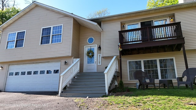 87 Dock St, Saugerties, NY 12477 - view of front of house with a balcony, an attached garage, and asphalt driveway