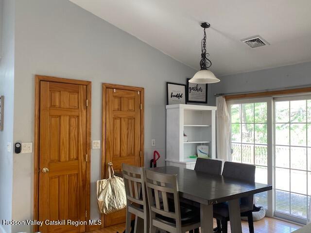87 Dock St, Saugerties, NY 12477 - dining room with vaulted ceiling, plenty of natural light, and wood finished floors