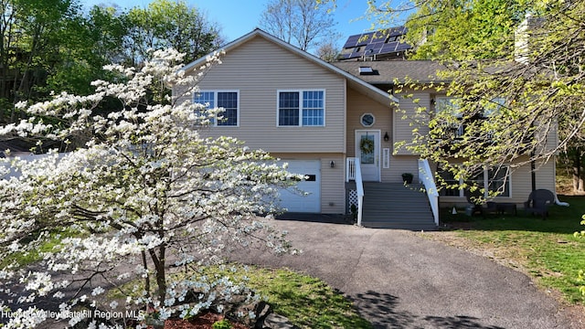 87 Dock St, Saugerties, NY 12477 - view of front of house with a garage and asphalt driveway