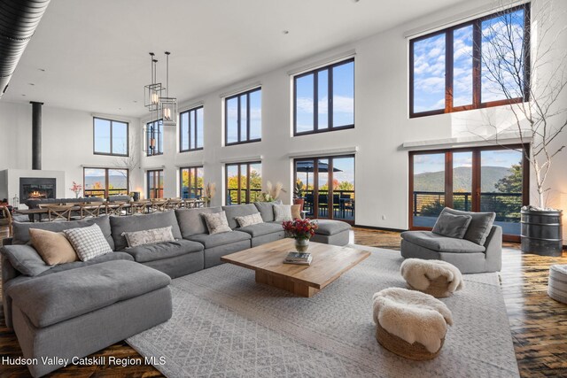 living room with a towering ceiling, hardwood / wood-style flooring, and a wealth of natural light