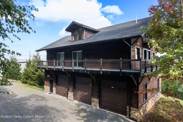 view of front of house featuring a balcony and a garage