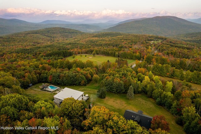 aerial view at dusk featuring a mountain view