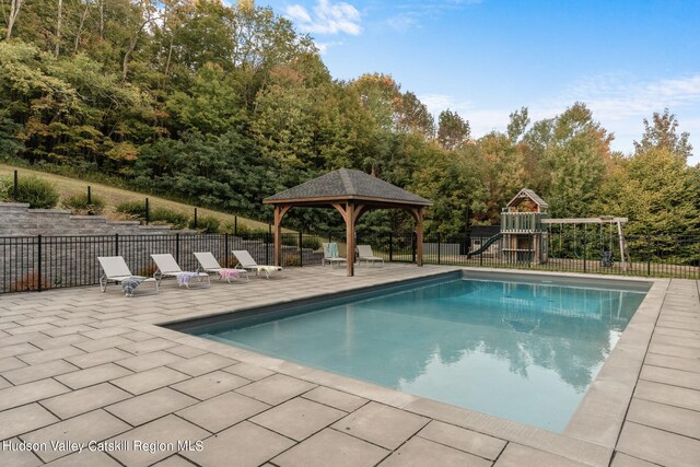 view of swimming pool featuring a gazebo, a patio area, and a playground