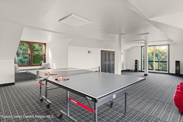 rec room with carpet, a healthy amount of sunlight, and lofted ceiling